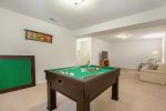 Lower level recreation room with flat screen TV and game table